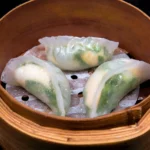 Handmade dumplings Bali served in bamboo steamer with translucent wrappers and fresh vegetable filling.